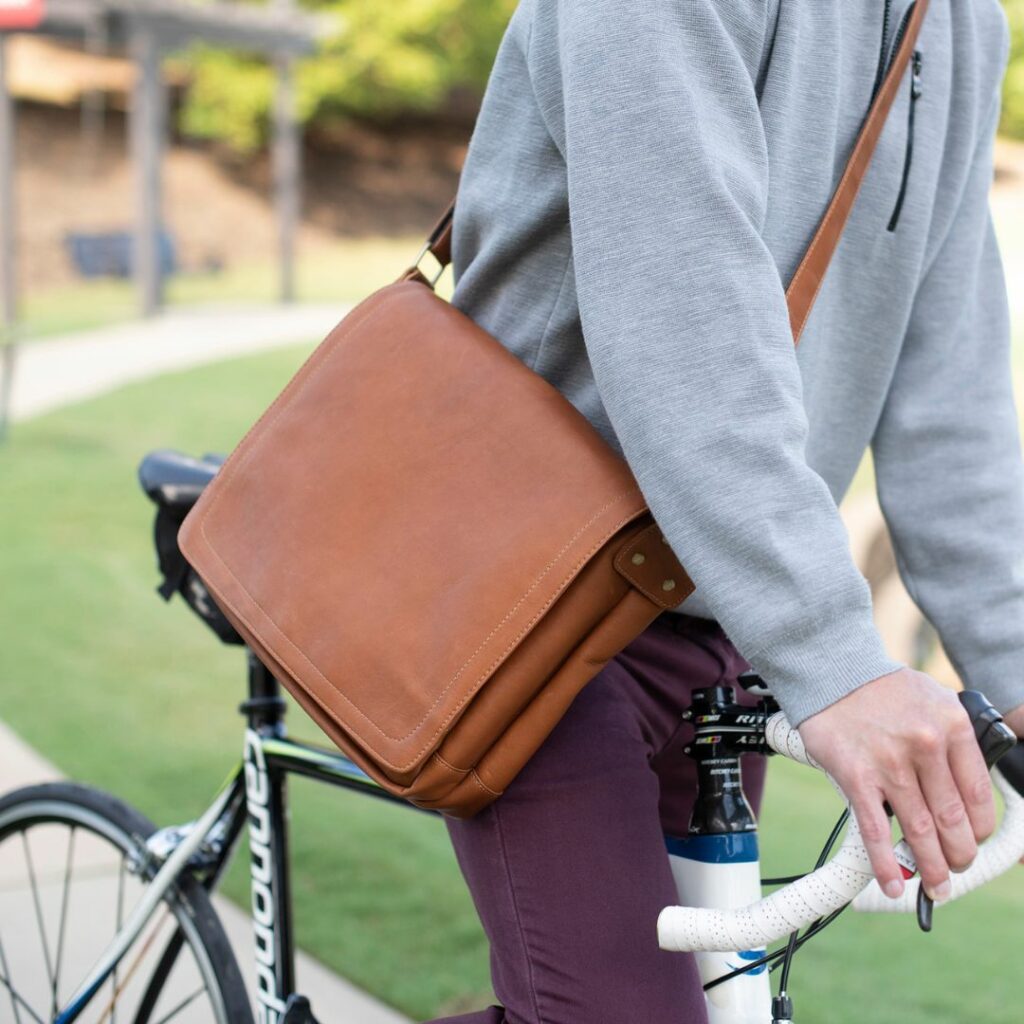 Man with messenger bag on bike